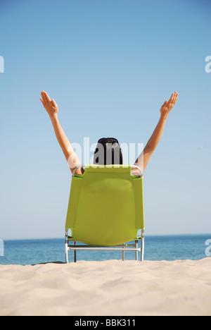 Young lady sunbathing on a deckchair Stock Photo