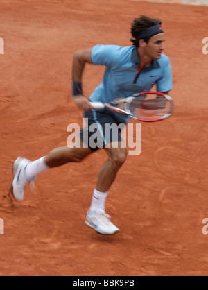 Tennis player Roger Federer running forward at Roland Garros Stock Photo