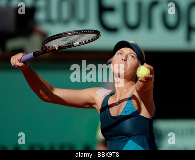 Tennis player Maria Sharapova plays a service and tosses the ball in the air at Roland Garros Stock Photo