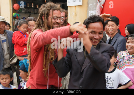 dreadlocked Spaniard having fun with local in Yuanyang China Stock Photo