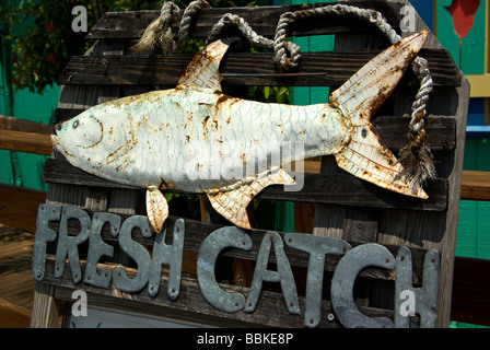 Rusted welded metal tarpon folk art sculpture sign in front of roadside bar restaurant Stock Photo