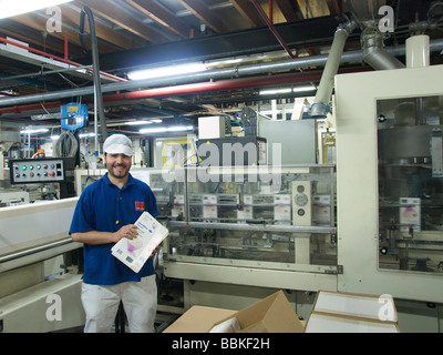 Smiling industry worker at packaging machine in rice factory Papendrecht Zuid Holland the Netherlands Stock Photo