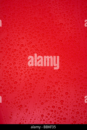 Water droplets on red paint Stock Photo