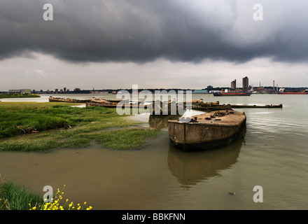 A panoramic view of old concrete barges beached on the Essex foreshore of the Thames Stock Photo