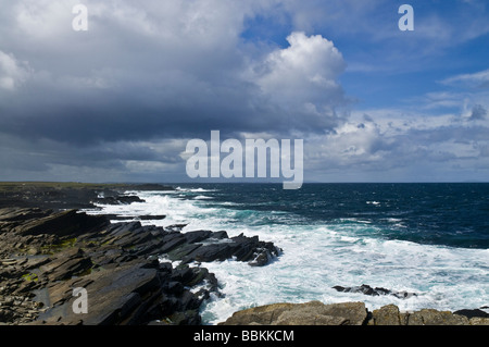 dh Bay of Ryasgeo NORTH RONALDSAY ORKNEY Blue skies black stormy clouds white waves and rocky coastline