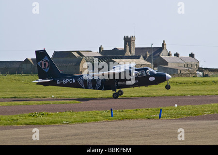 dh Airport NORTH RONALDSAY ORKNEY Loganair Britten Norman Islander airplane landing on airfield runway plane small aircraft turbo prop
