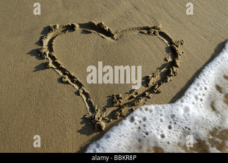 Symbol of a heart drawn in the sand Stock Photo