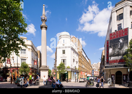 People enjoy warm summer day around Seven Dials West End London United Kingdom Stock Photo