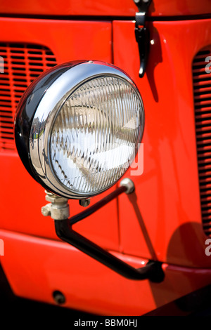 Antique headlight on red car Stock Photo