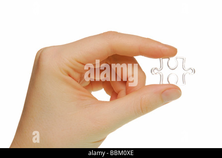 Female hand with jigsaw piece, symbolic for piece of the puzzle Stock Photo