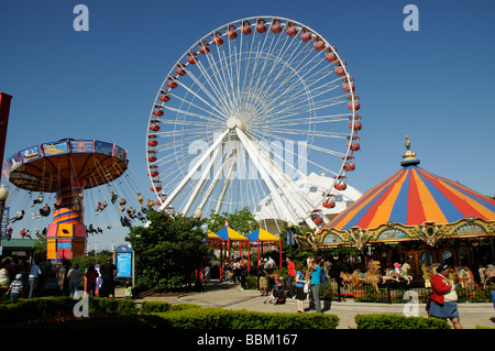 Funfair rides Ferris Wheel and the Wave Swinger on Navy Pier Chicago Illinois USA f Stock Photo