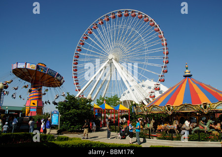 Funfair rides Ferris Wheel and the Wave Swinger on Navy Pier Chicago Illinois USA f Stock Photo