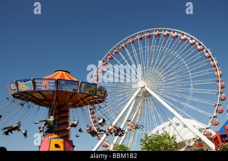 Funfair rides Ferris Wheel and the Wave Swinger on Navy Pier Chicago Illinois USA Stock Photo