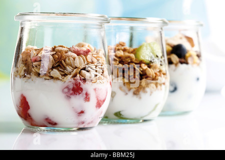 Muesli with yoghurt and fruit in small glass jars Stock Photo