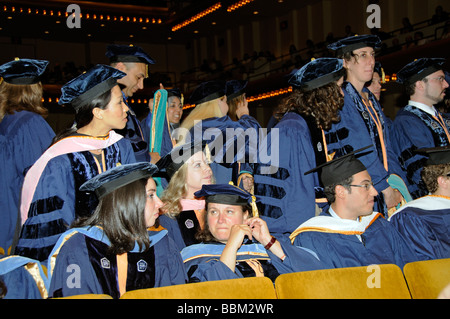 Graduation ceremony doctoral graduates wearing caps and gowns during the presentations at Lincoln center new York USA Stock Photo