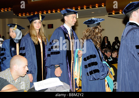 Graduation candidates in caps and gowns wait for Western Governors