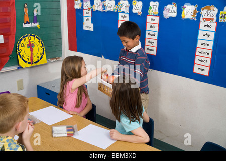 5-6 year old children child helping  students share sharing racial diversity racially diverse multicultural multi cultural interracial United States Stock Photo