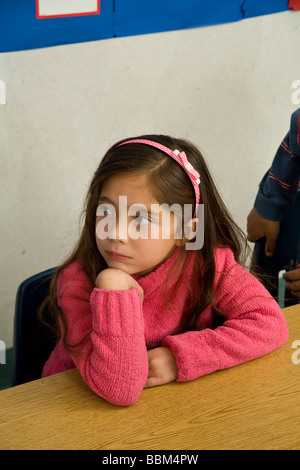 5-6 year old student multi ethnic racial diversity racially diverse multicultural Hispanic girl classroom listening teacher United States Stock Photo