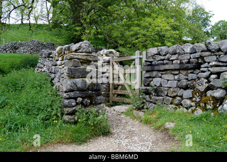 A gate in a dry stone wall near Malham Village in the Yorkshire Dales Stock Photo