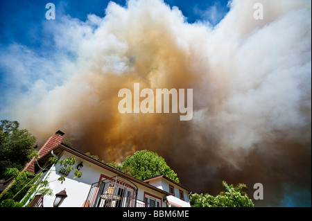 Smoke from Jesusita fire fills sky over house in evacuation zone, Santa Barbara, California, May 6, 2009 Stock Photo