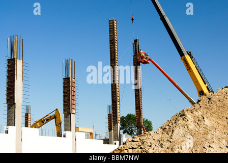 workers assembling forms on a column in a construction site Stock Photo