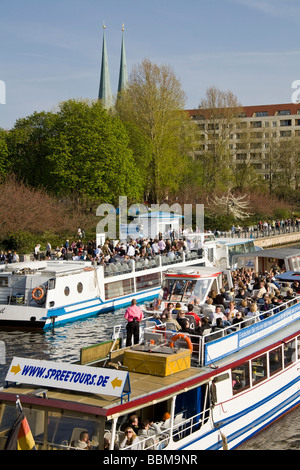 Boat excursion through Berlin, two sightseeing boats on Spree River, Nikolaiviertel district in the back, Berlin-Mitte Stock Photo