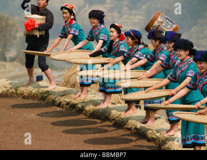Hani Akha women sifting rice at a festival in Yuanyang China Stock Photo