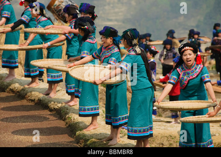 Hani Akha women sifting rice at a festival in Yuanyang China Stock Photo