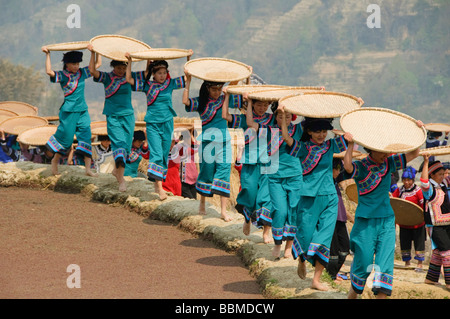 Hani Akha women and their rice sifting baskets at a festival in Yuanyang China Stock Photo