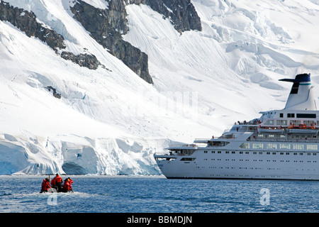 Antarctica, Antarctic Peninsula.   A zodaic with passengers returns to an expedition cruise ship anchored in Paradise Harbour. Stock Photo