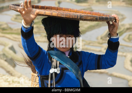 Hani Akha woman with her rice sifting basket in Yuanyang China Stock Photo