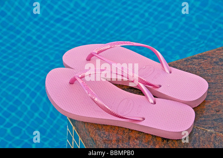 Pink flip flops at the pool Stock Photo