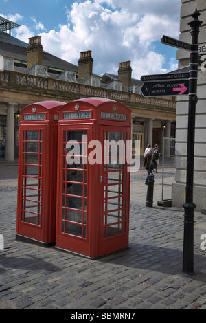 Two iconic red telephone boxes in Covent garden Market in London Stock Photo