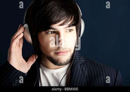 Young Man listening to music with headphones Stock Photo