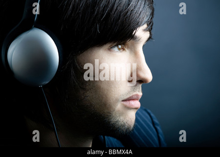 Young Man listening to music with headphones Stock Photo