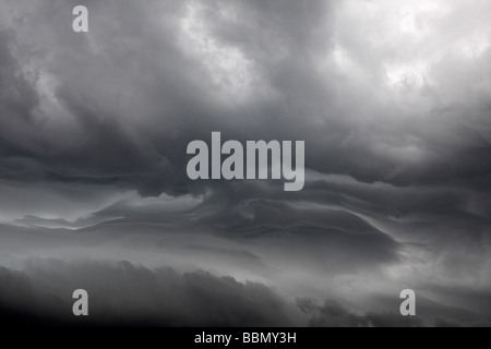 Turbulent stratified area of upper layers of thunderstorm showing clear delineation between different layers of air. Stock Photo