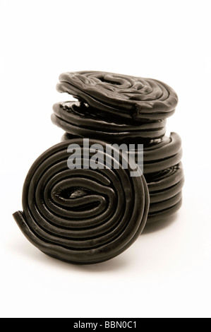Black liquorice wheels on a white background Stock Photo
