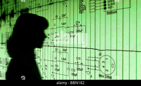 female electronic engineer studying circuit printout Stock Photo