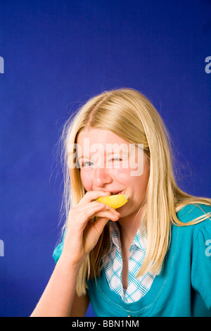 Portrait of young girl eating sour lemon, studio shot cut out MR  © Myrleen Pearson Stock Photo