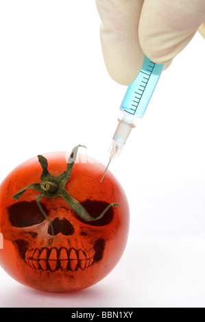 Syringe in tomato, symbolic image for genetically modified foods Stock Photo