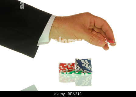 Manager's hand placing casino chips, symbolic image for setting a stake Stock Photo