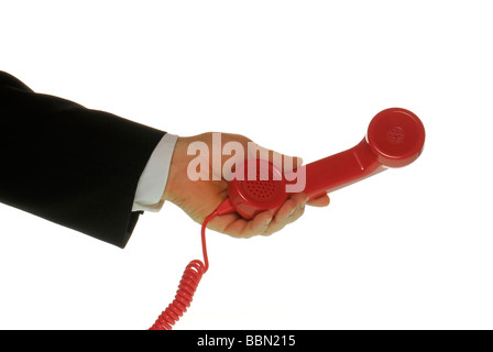 Manager's hand holding a telephone handset Stock Photo