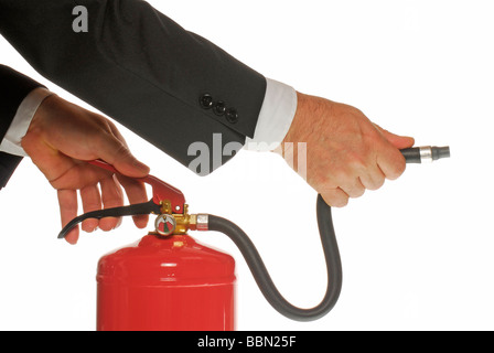 Manager's hand holding a fire extinguisher, symbolic image Stock Photo