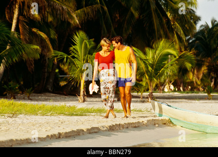 Young romantic couple 20 30 walking on beach Stock Photo