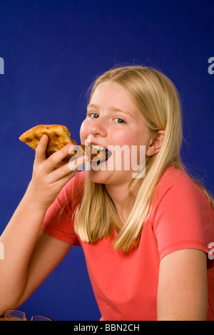 Portrait of girl eating slice of pizza, studio shot cut out MR  © Myrleen Pearson Stock Photo