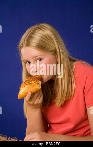 Portrait of girl eating slice of pizza, studio shot cut out MR  © Myrleen Pearson Stock Photo