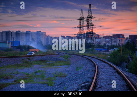 An electricity pylon with the sun setting behind Stock Photo
