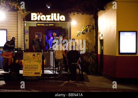 young people queuing to get into a nightclub Stock Photo