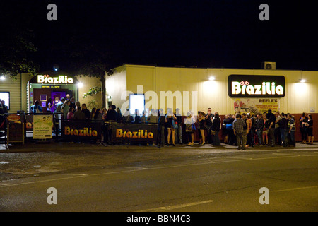 young people queuing to get into a nightclub Stock Photo