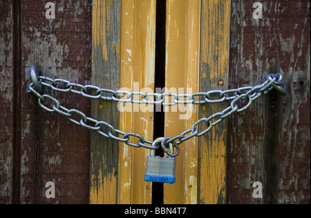 Lock and chain securing an old door Stock Photo
